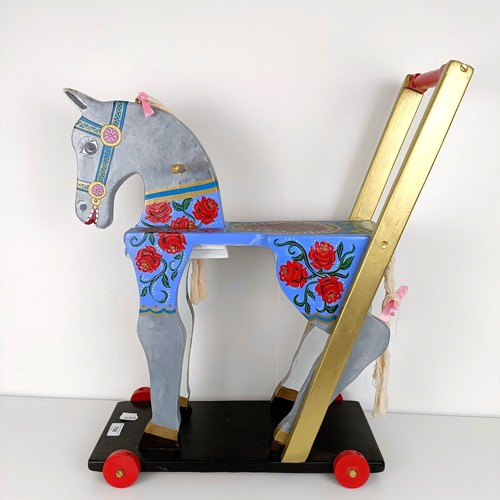 758 - A painted push along horse, 61 cm high