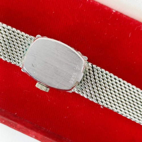 570 - A ladies 18ct white gold Girard-Perregaux wristwatch, with a diamond bezel, boxed