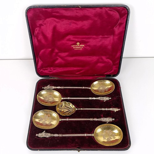 650 - A Victorian silver gilt fruit set, comprising four spoons, and a sifter spoon, with figural handles,... 