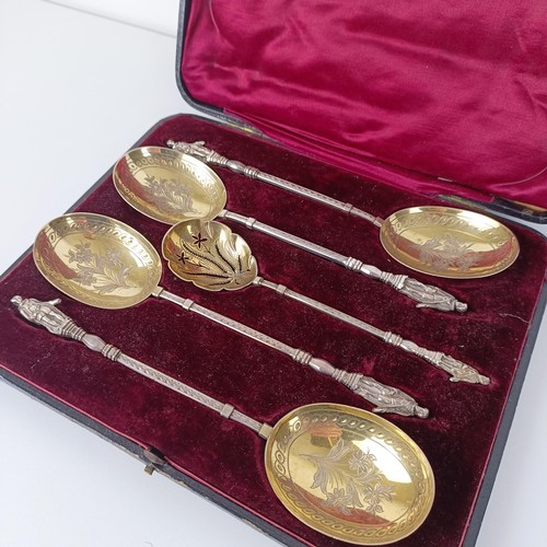 650 - A Victorian silver gilt fruit set, comprising four spoons, and a sifter spoon, with figural handles,... 