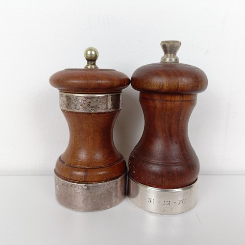 654 - A carved wood and silver mounted peppermill, and another (2)