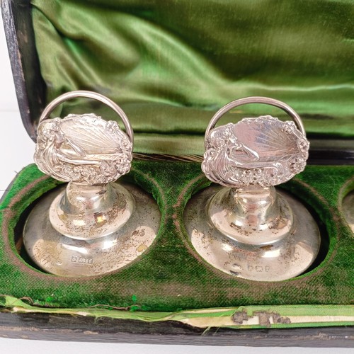 656 - A set of three silver Art Nouveau style menu holders, and another set of three, bases filled, cased