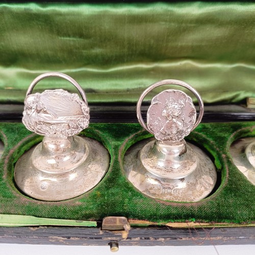 656 - A set of three silver Art Nouveau style menu holders, and another set of three, bases filled, cased