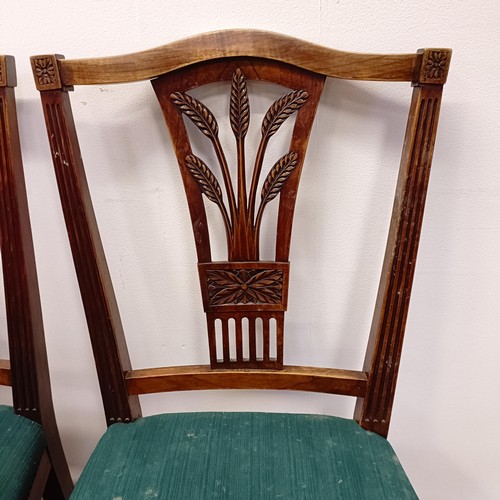 985 - A set of eight camphorwood dining chairs, with pierced splat backs and padded seats (6+2)