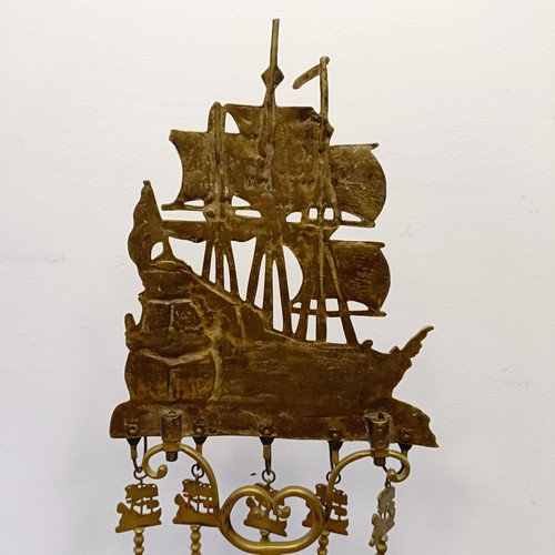 987 - A Dutch brass fire companion set, the stand with a large galleon finial, 120 cm high