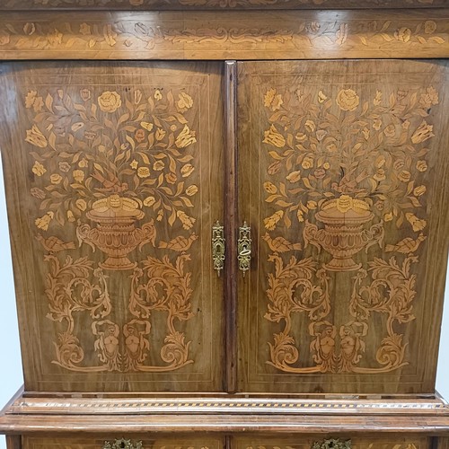 999 - A 19th century Dutch mahogany linen press, with floral marquetry decoration, the two cupboard doors ... 