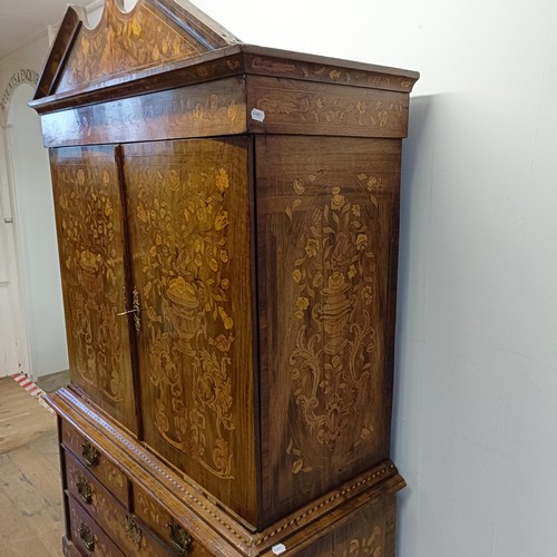 999 - A 19th century Dutch mahogany linen press, with floral marquetry decoration, the two cupboard doors ... 