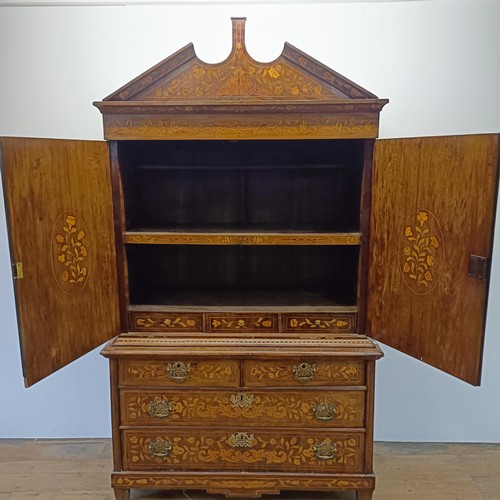 999 - A 19th century Dutch mahogany linen press, with floral marquetry decoration, the two cupboard doors ... 