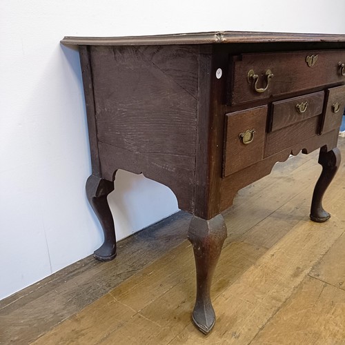 1006 - A 19th century oak lowboy, having four drawers, on cabriole legs, 89 cm wide