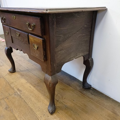 1006 - A 19th century oak lowboy, having four drawers, on cabriole legs, 89 cm wide