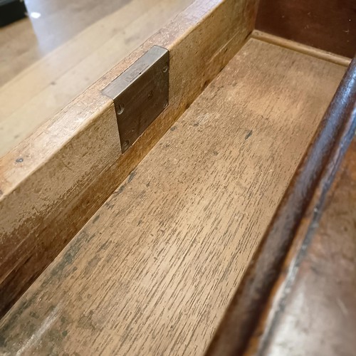 1014 - A mahogany pedestal desk, of small proportions, with an inset top above nine drawers, 92 cm wide