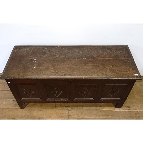 1026 - An 18th century oak coffer, carved lozenges, on stile legs, 140 cm wide