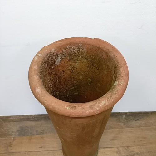 1042 - A terracotta chimney pot, 107 cm high