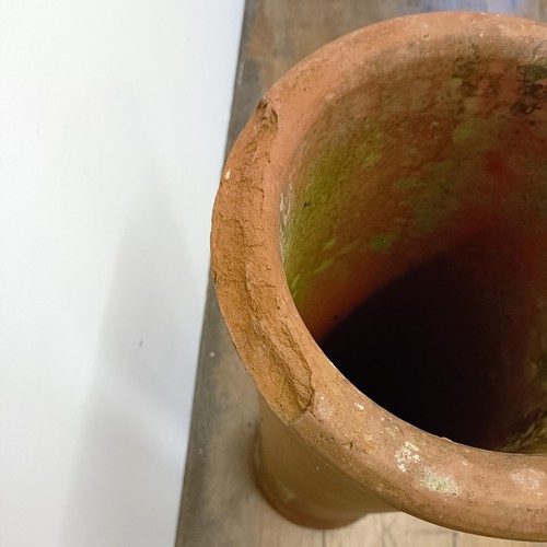 1042 - A terracotta chimney pot, 107 cm high