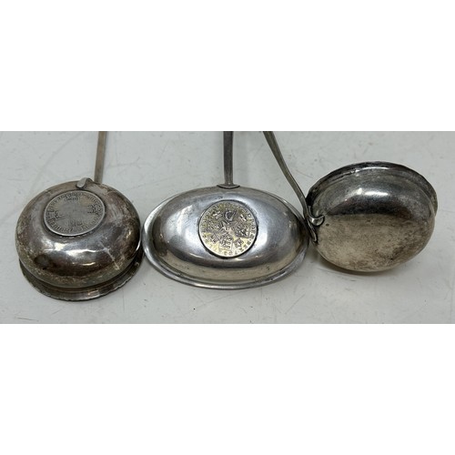 701A - A George III toddy ladle, inset with a coin, another, and a George III toddy ladle (3)