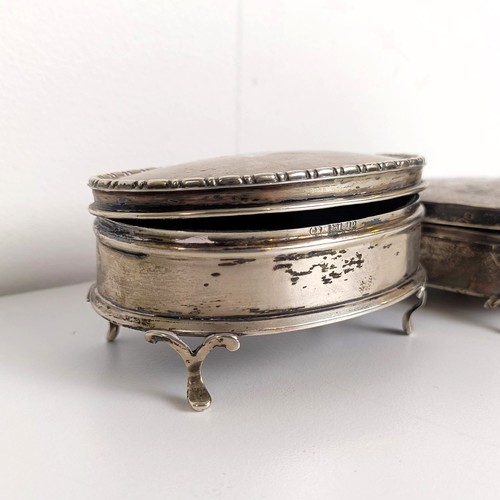 723A - A George V silver oval dressing table box, and another (2)