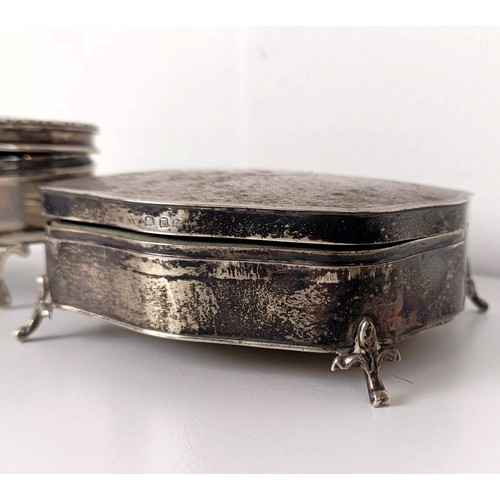 723A - A George V silver oval dressing table box, and another (2)