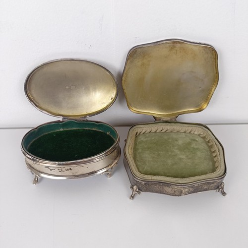 723A - A George V silver oval dressing table box, and another (2)