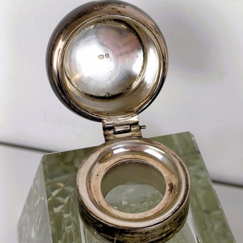 722A - A cut glass inkwell, with a silver mount, London 1948, and another (2)