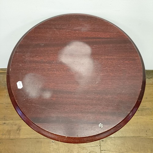 1054 - A pub table, with a cast metal base, 60 cm diameter