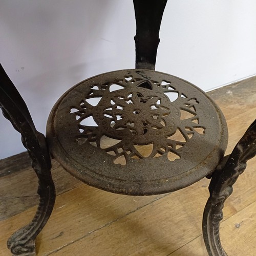 1054 - A pub table, with a cast metal base, 60 cm diameter