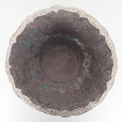 705A - A Burmese silver coloured metal bowl, decorated hunters, their prey, and repeated foliate forms