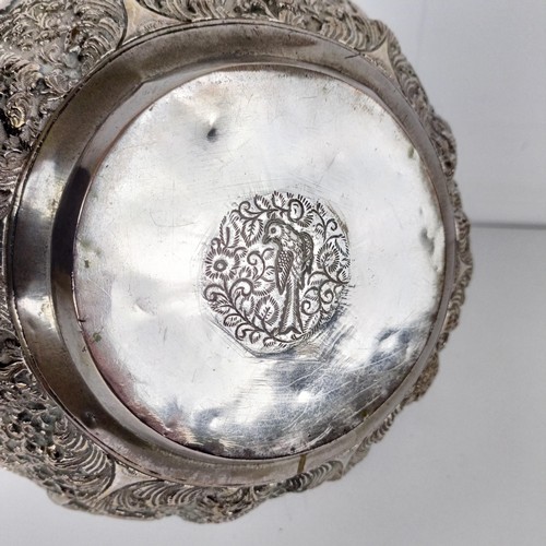 705A - A Burmese silver coloured metal bowl, decorated hunters, their prey, and repeated foliate forms