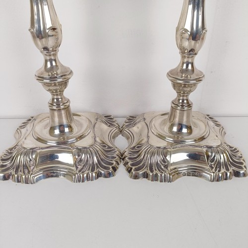 704A - A pair of George III style silver candlesticks, London 1909, 30 cm high (2)