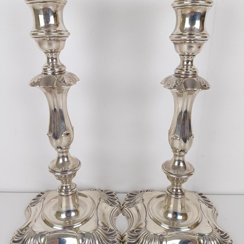 704A - A pair of George III style silver candlesticks, London 1909, 30 cm high (2)