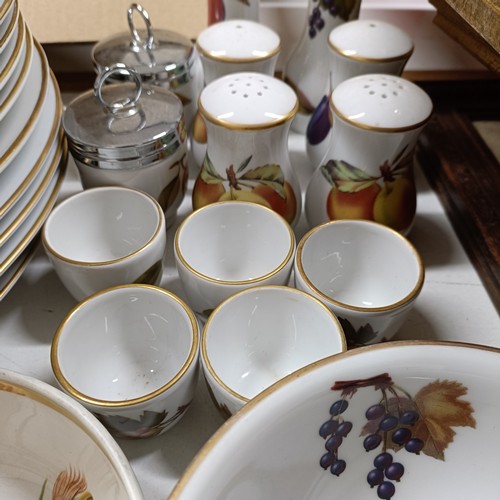 821 - An extensive Royal Worcester Evesham service, comprising plates, tureens, teapots, storage jars, cup... 