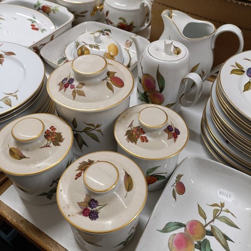 821 - An extensive Royal Worcester Evesham service, comprising plates, tureens, teapots, storage jars, cup... 