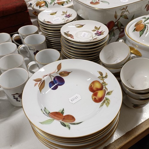 821 - An extensive Royal Worcester Evesham service, comprising plates, tureens, teapots, storage jars, cup... 