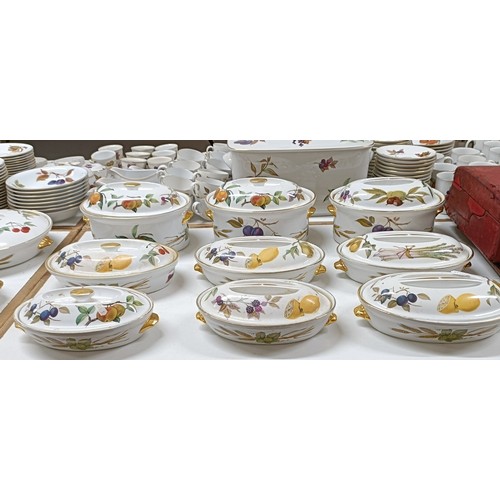 821 - An extensive Royal Worcester Evesham service, comprising plates, tureens, teapots, storage jars, cup... 