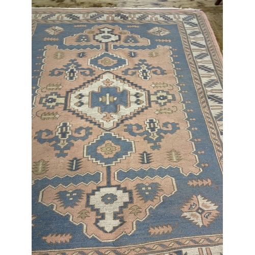 1061 - A Turkish pink ground rug, 245 x 196 cm