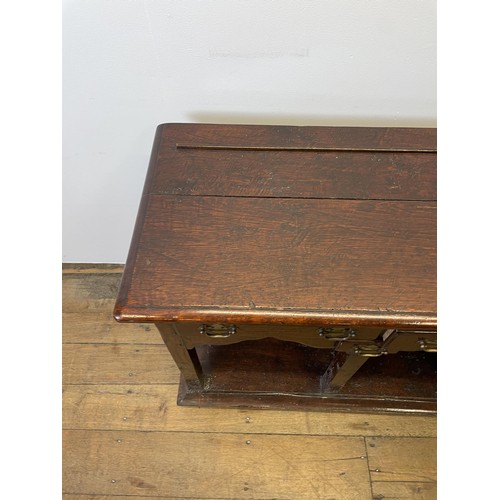 931 - A George III oak dresser base, with five drawers and a potboard base, 131 cm wide