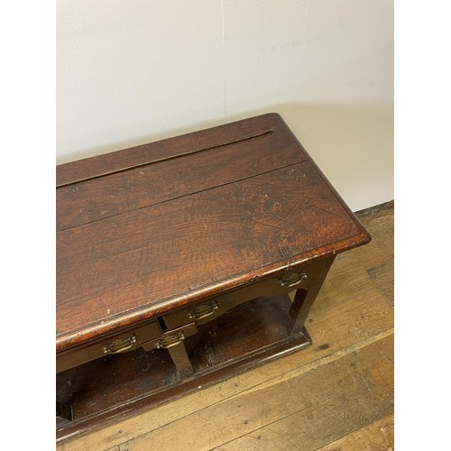 931 - A George III oak dresser base, with five drawers and a potboard base, 131 cm wide