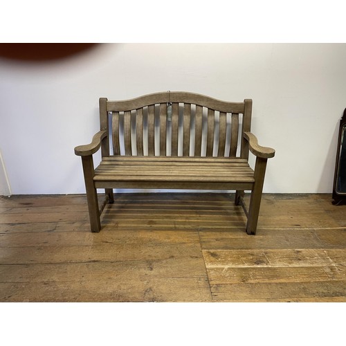 1058 - A teak garden bench, 142 cm wide