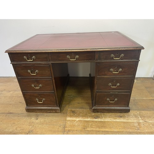 1028 - A mahogany pedestal desk, the inset top above nine drawers, 126 cm wide