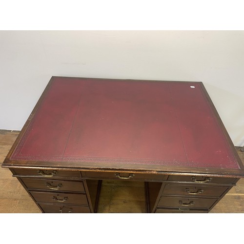 1028 - A mahogany pedestal desk, the inset top above nine drawers, 126 cm wide