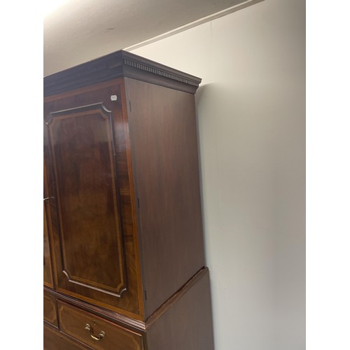 1003 - A late 19th/early 20th century inlaid mahogany linen press, the top with two cupboard doors, to reve... 