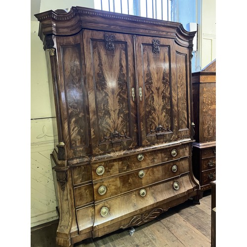 998 - An 18th century Dutch armoire, with two cupboard doors to reveal shelf and drawers, on a base with t... 