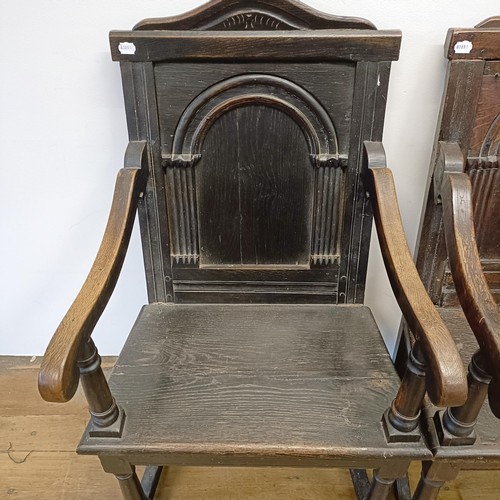 991 - A 17th/18th century oak wainscot armchair, with an arched panel back, on turned legs, and another, l... 