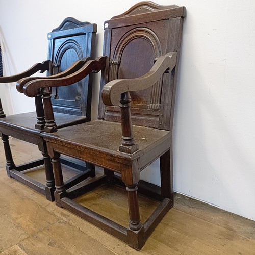 991 - A 17th/18th century oak wainscot armchair, with an arched panel back, on turned legs, and another, l... 