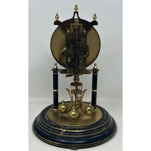 895 - A mantel clock, with an eight day movement, in a glass dome, 33 cm high