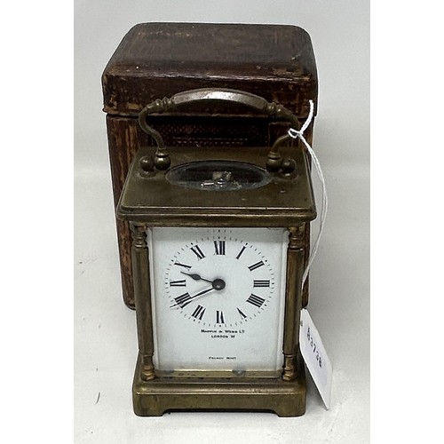 897 - A carriage clock, by Mappin & Webb, London, in a brass and glass case, 14 cm high, with a leather tr... 