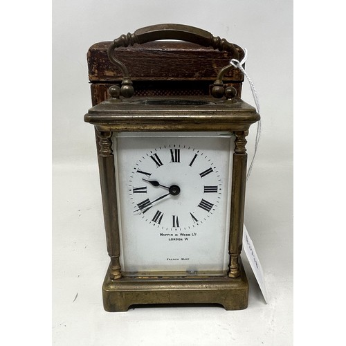 897 - A carriage clock, by Mappin & Webb, London, in a brass and glass case, 14 cm high, with a leather tr... 