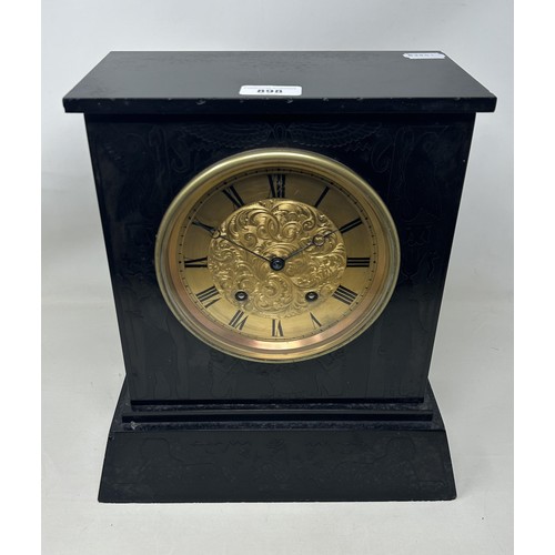 898 - A mantel clock, with an eight day movement, in a slate case, 27 cm wide