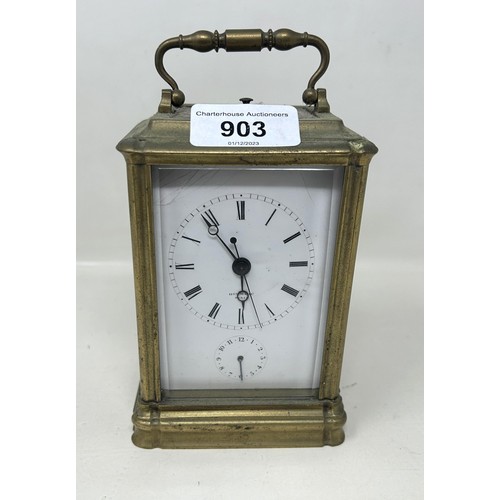 903 - A carriage clock, with a repeat and an alarm, in a brass and glass case, 16 cm high