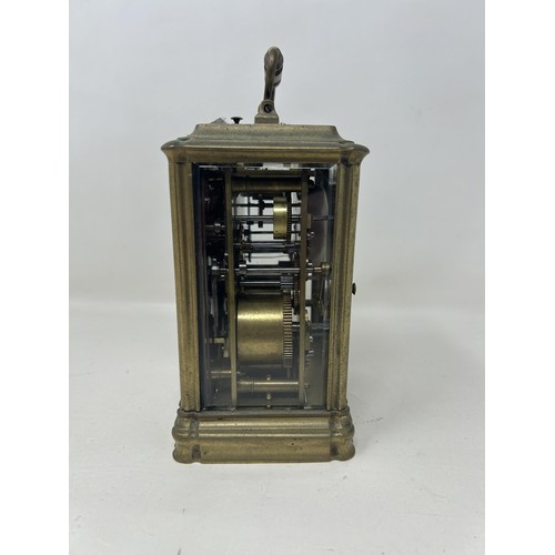 903 - A carriage clock, with a repeat and an alarm, in a brass and glass case, 16 cm high