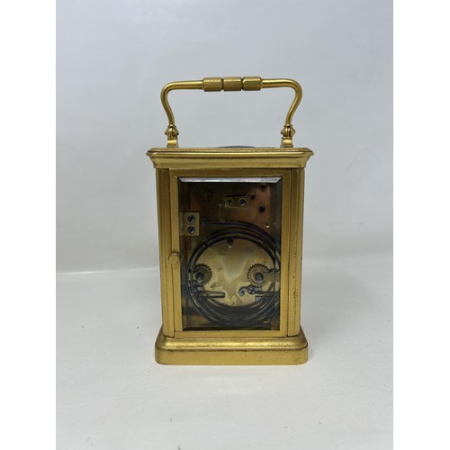 904 - A carriage clock, in a brass and glass case, 18 cm high